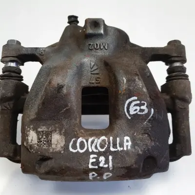 Toyota Corolla XII E21 PRZEDNI ZACISK HAMULCOWY prawy przód PASAŻERA P.P